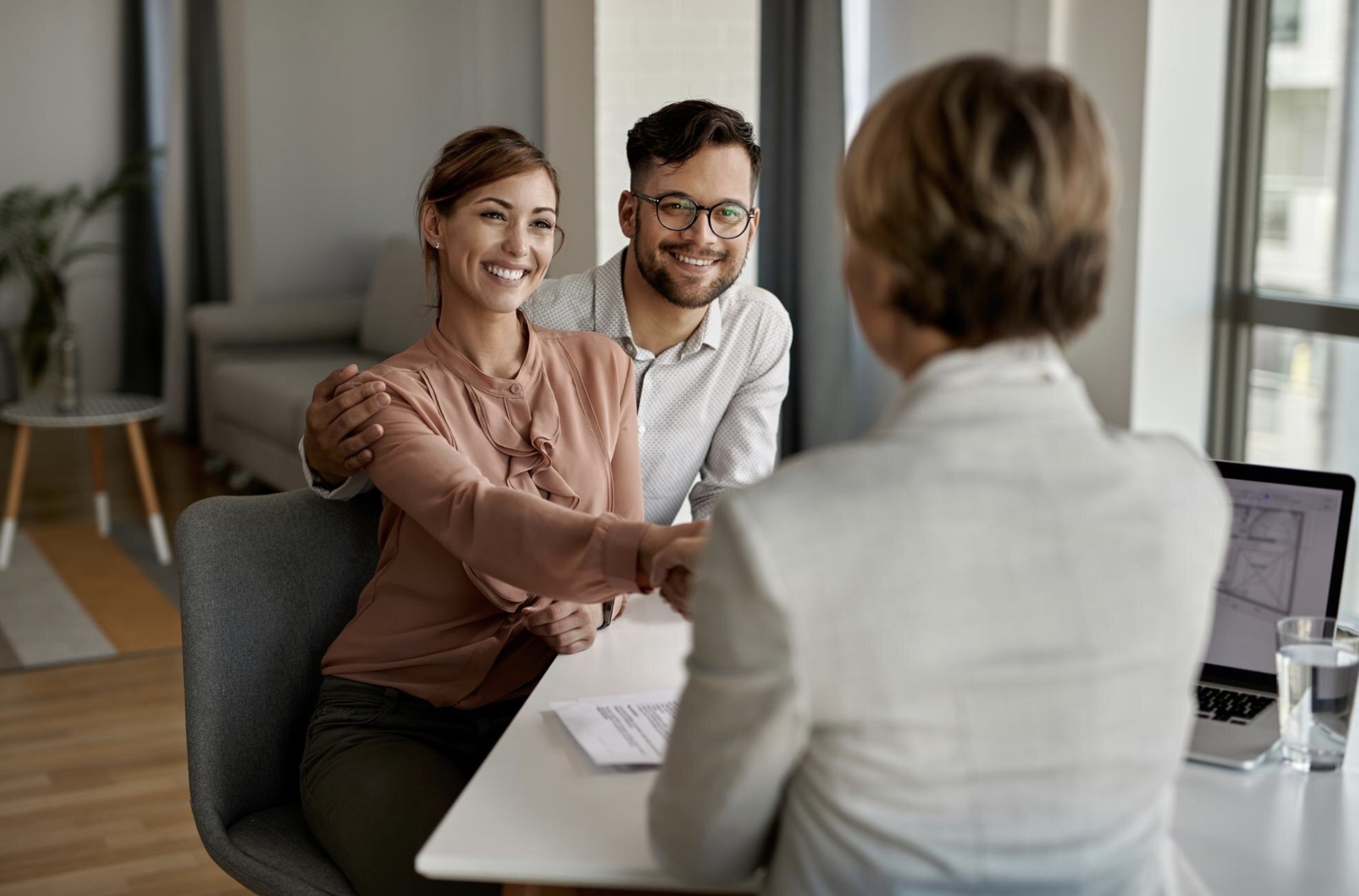 Young happy couple with agent